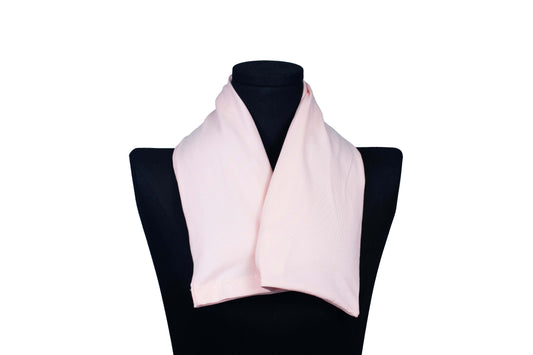Pink handmade organic microwavable heated neck wrap for natural neck pain relief on a mannequin
